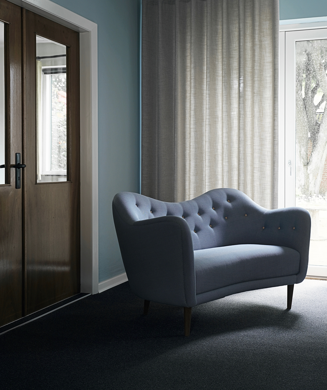 The 46 Sofa with walnut legs and 'Rime' upholstery in the colour '721'.