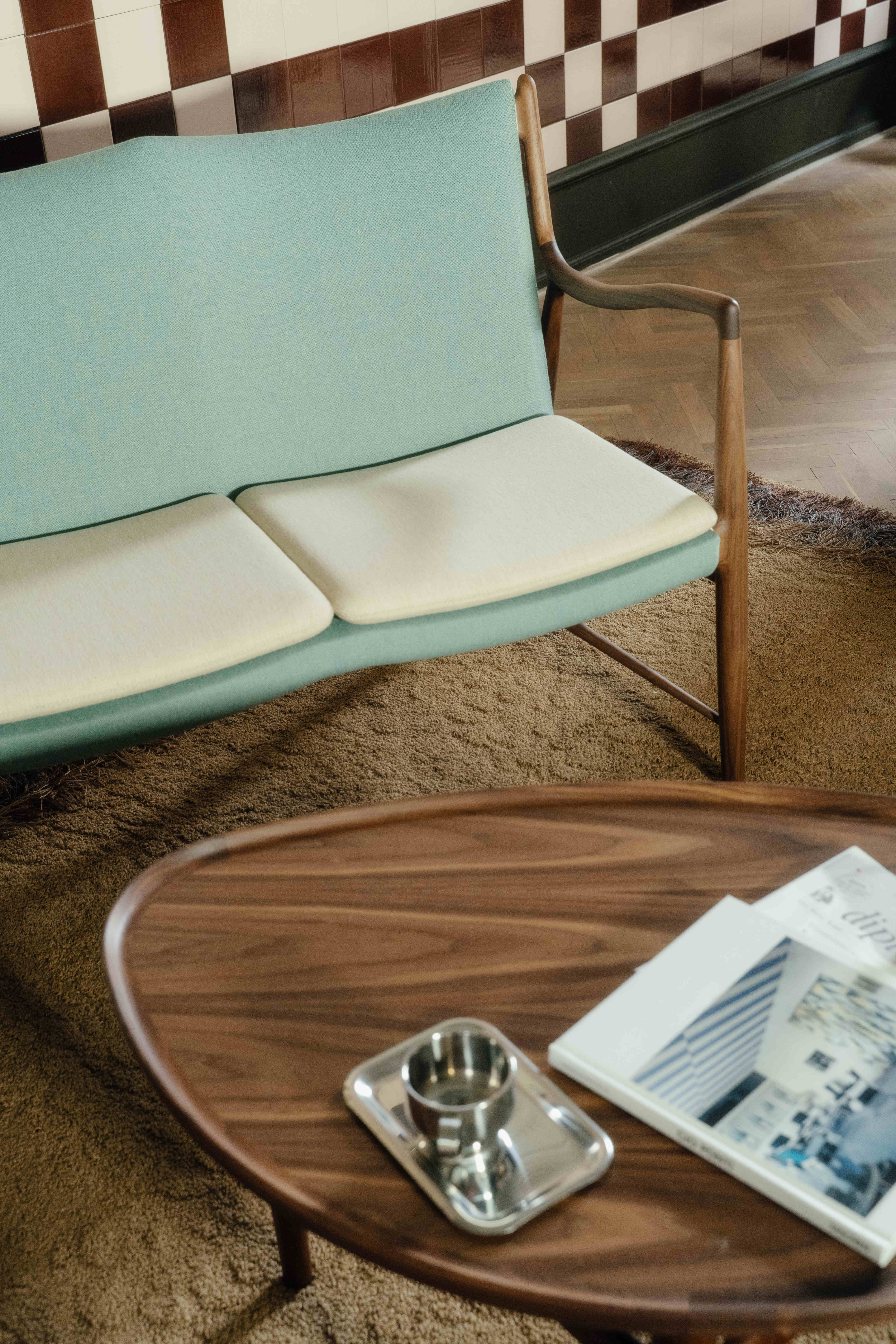 The 45 Sofa in walnut with upholstery in 'Watercolour', in the colors 'Himalaya' and 'Soft Linen'.