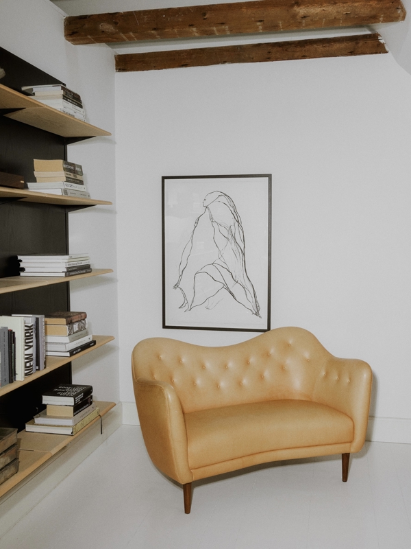 The 46 Sofa with walnut legs upholstered with 'Vegetal' leather.