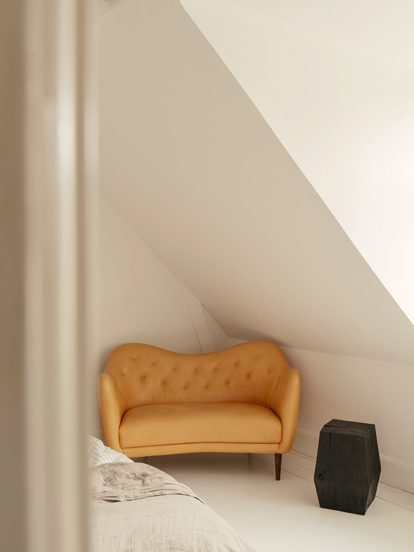 The 46 Sofa with walnut legs upholstered with 'Vegetal' leather.