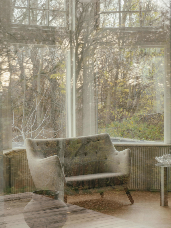The Poet Sofa with walnut legs upholstered in Hallingdal textile in the color '200' on the backrest and '270' on the seat.